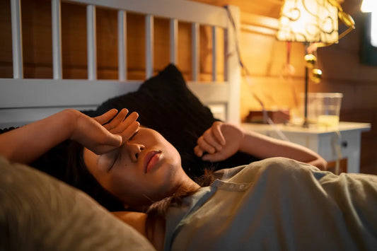 Woman laying in bed, struggling with hot flushes 