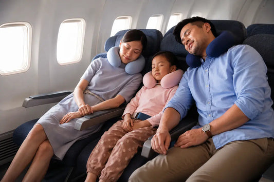 A family using cooling travel pillows to sleep on a plane 
