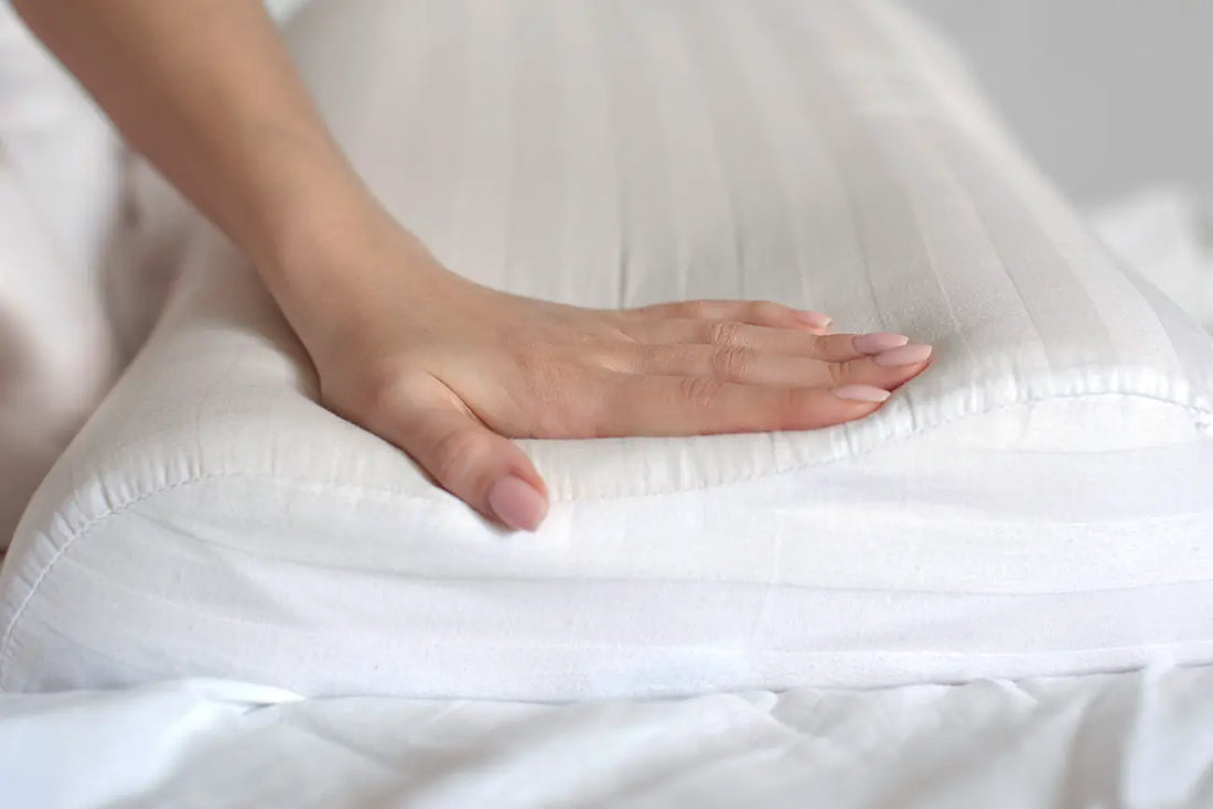 Hand pressing on a firm cooling pillow 