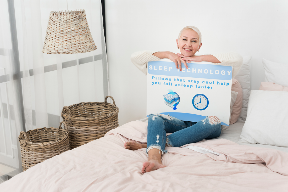 Woman on a white bed, holding a poster showing  'pillows that stay cool ' information